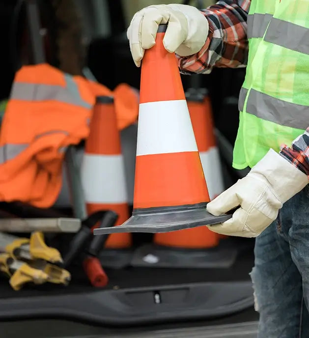 Worker with safety cone